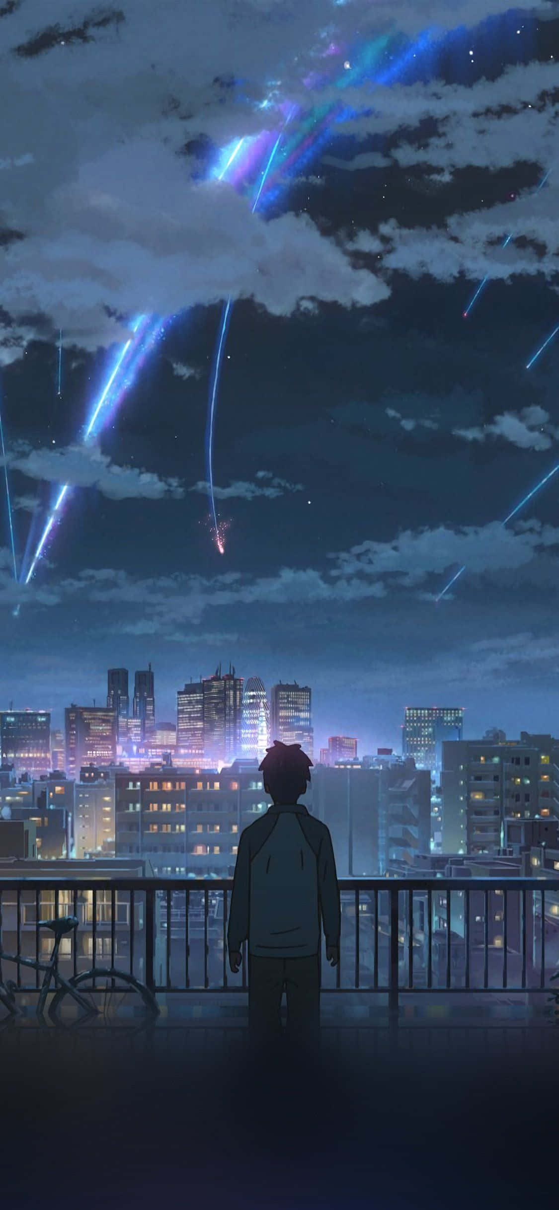 一名男子在夜晚俯瞰城市 壁纸